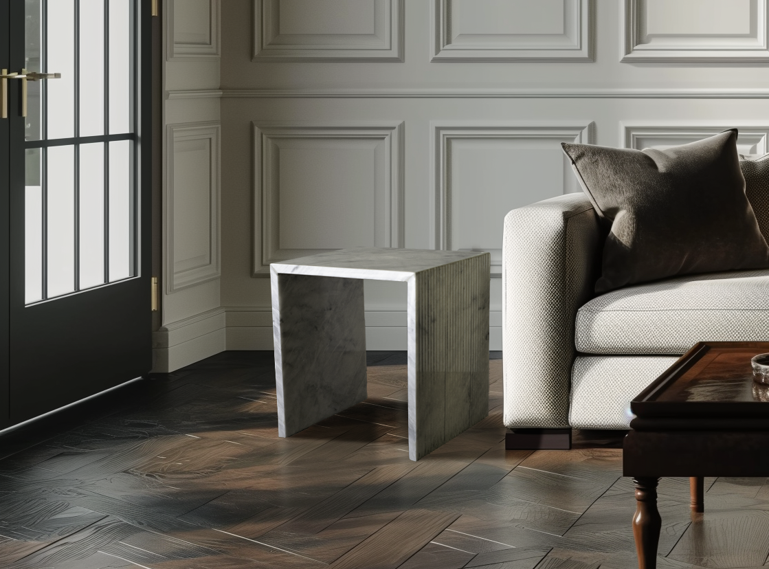 Stria side table in white marble with a unique corrugated texture in a contemporary living room.