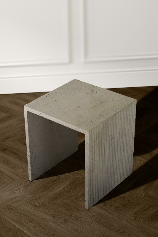 Handcrafted travertine side table showcasing its smooth, polished surface and natural variations.