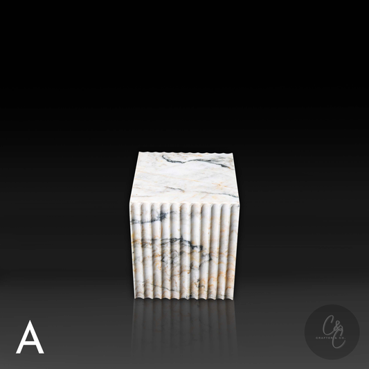 Calacatta Monet marble corrugated cube side table top side view highlighting dramatic veining