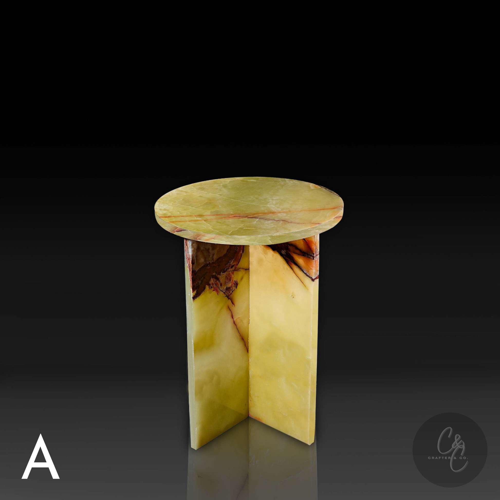 Green onyx cross side table with a dark background