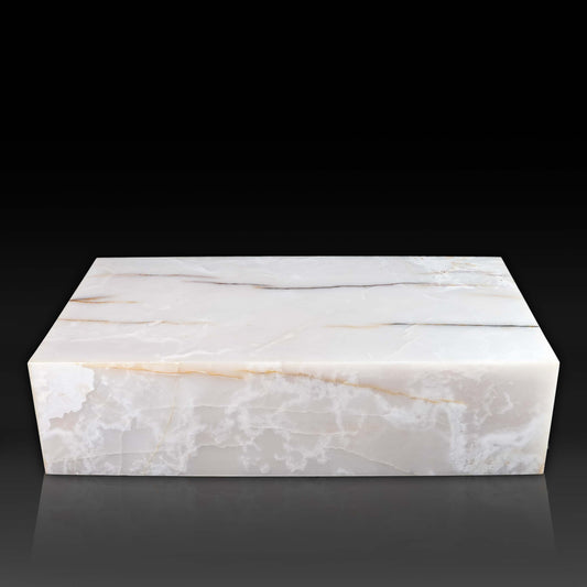 Front view of large White Onyx block coffee table with polished natural stone finish