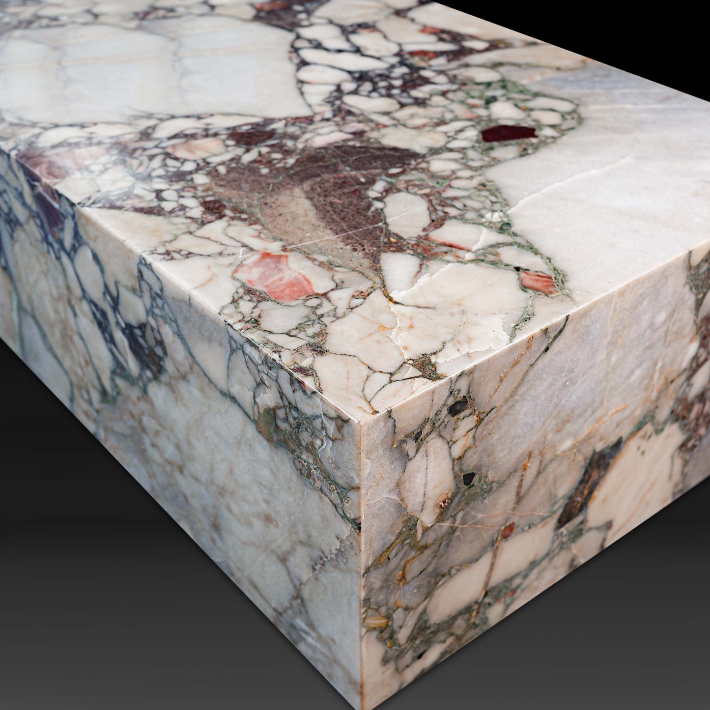 Angled view of the Small Block Coffee Table in Breccia Capraia Marble highlighting its natural stone veining.