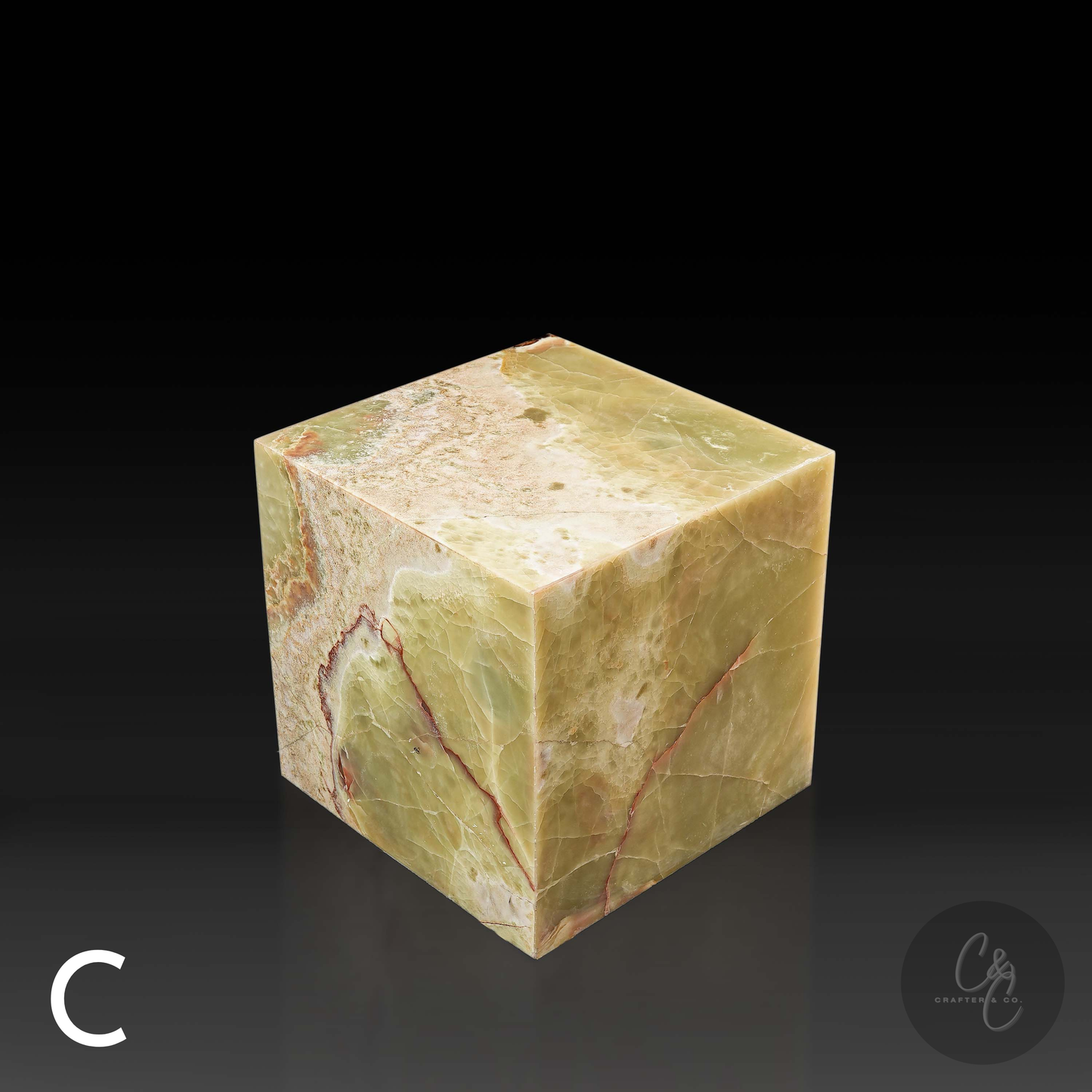 Green onyx cube side table variation C shown from a top angle, highlighting its polished surface and natural veining.