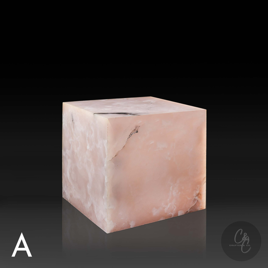 Pink onyx cube side table variation A shown from the front profile, highlighting its translucent blush tones and natural veining.