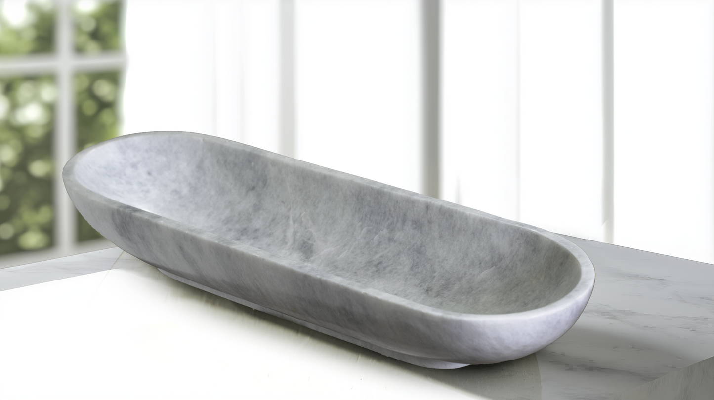 Luxury Serenity Oval White Marble Bowl displayed as a decorative centerpiece on a modern console table.