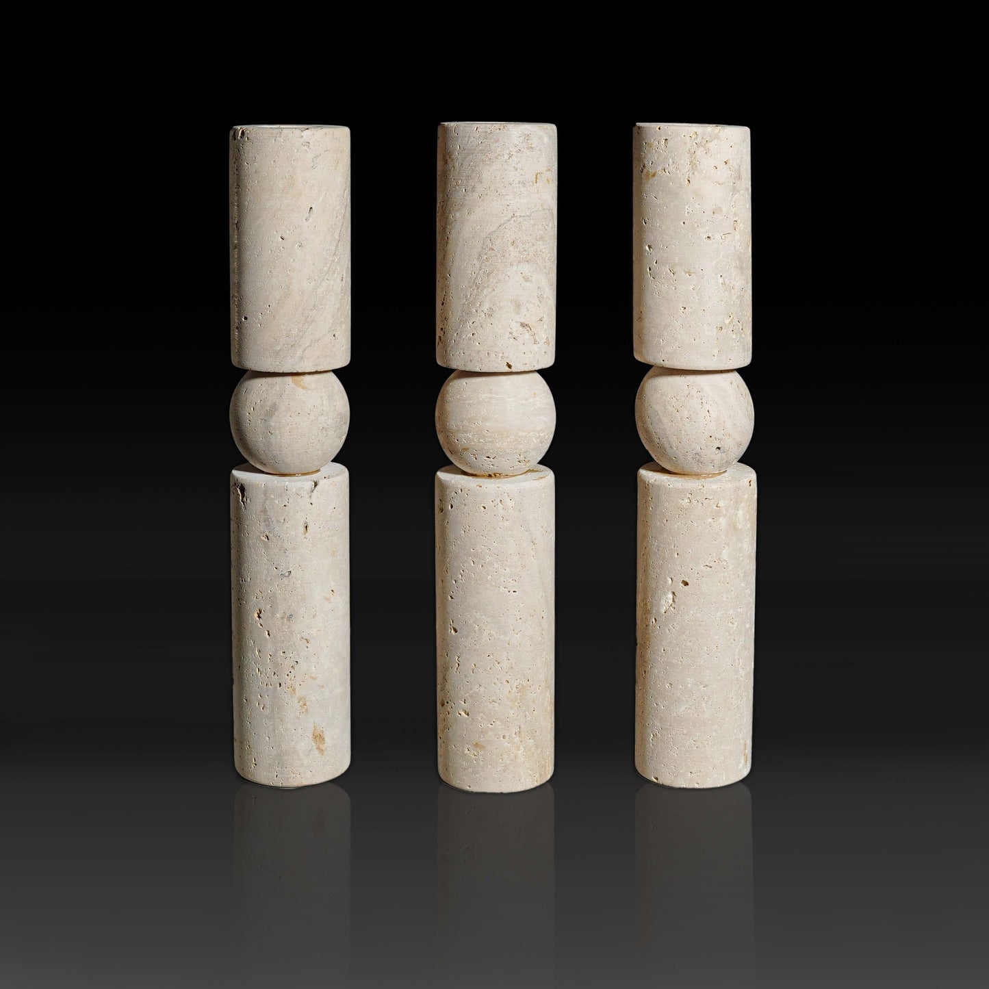 Set of three Solis Travertine natural stone candle holders showcasing warm textured travertine and sculptural design.