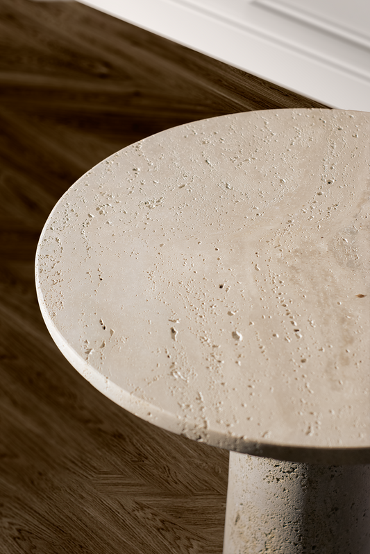 Close-up of the Zenith Travertine Side Table highlighting the natural travertine texture and honed stone. finish