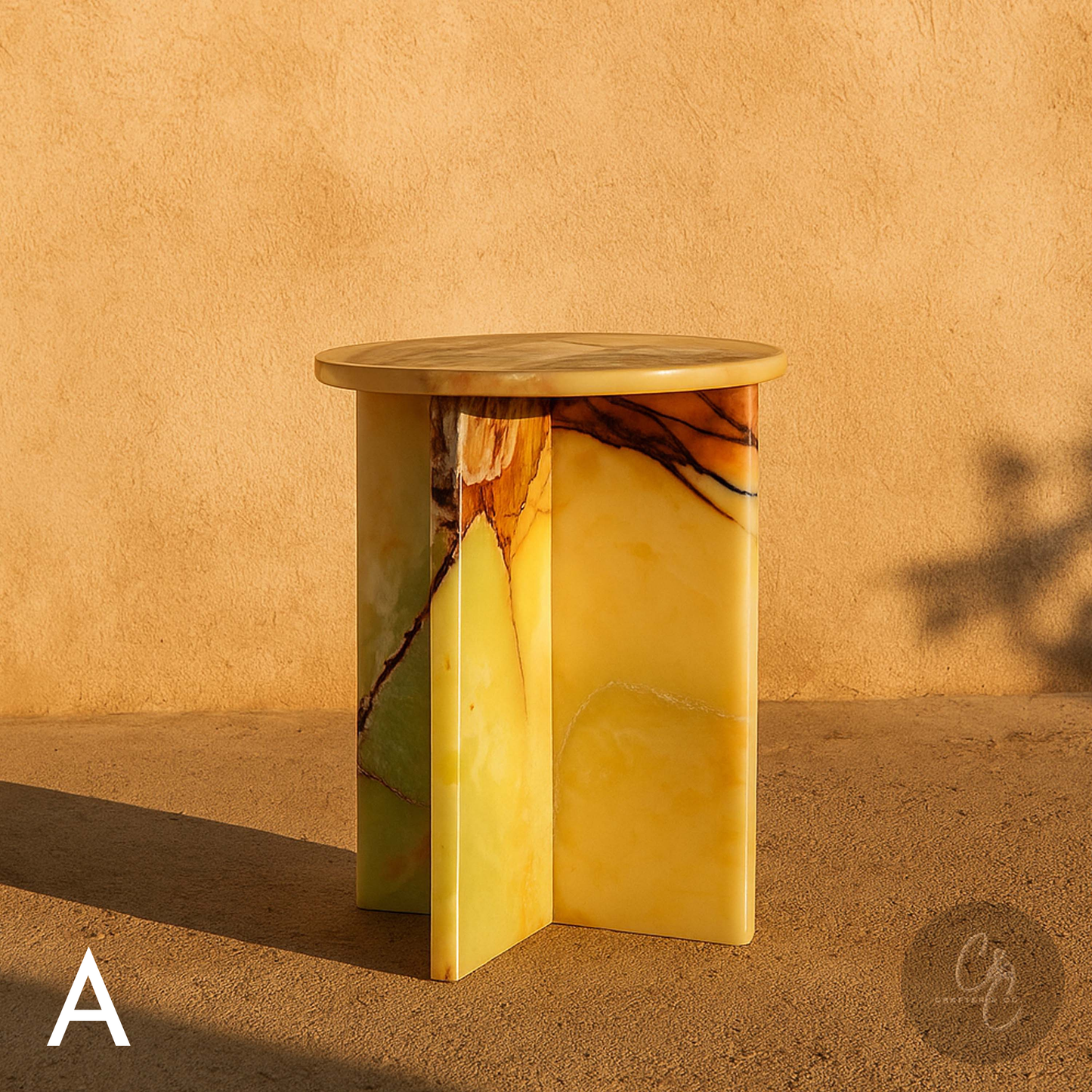 Green Onyx side cross table against a beige wall.