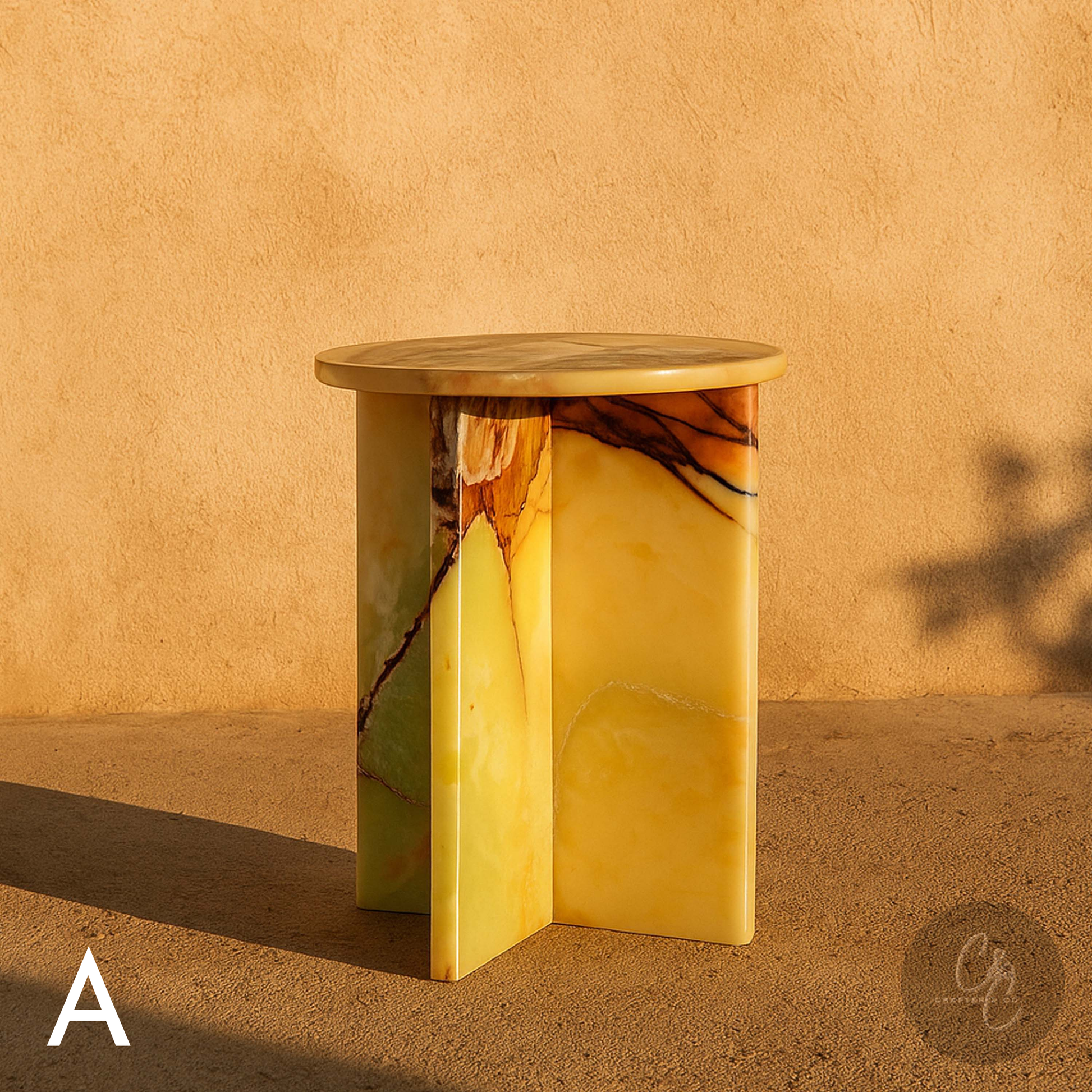 Green Onyx side cross table against a beige wall.