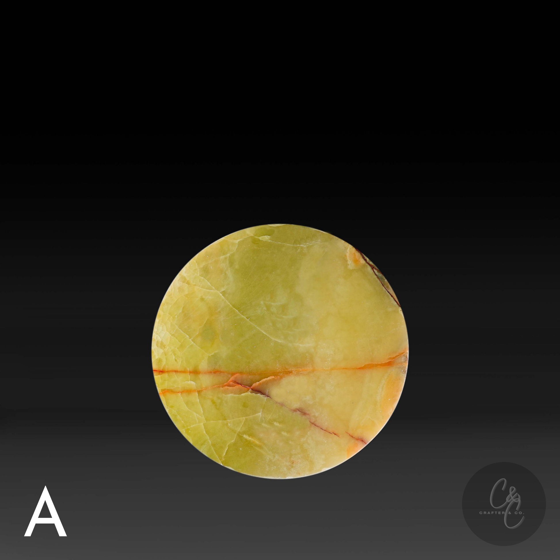 Round top of green onyx cross side table with bronze veins on a black background.