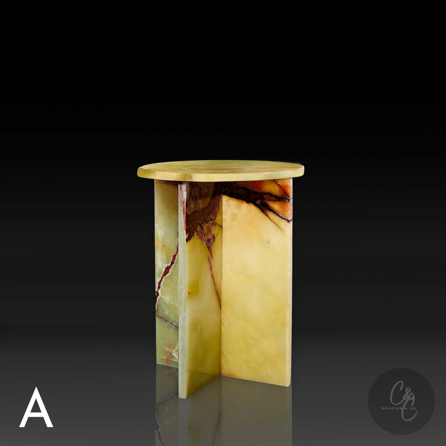 Green onyx cross side table angle view with a dark background