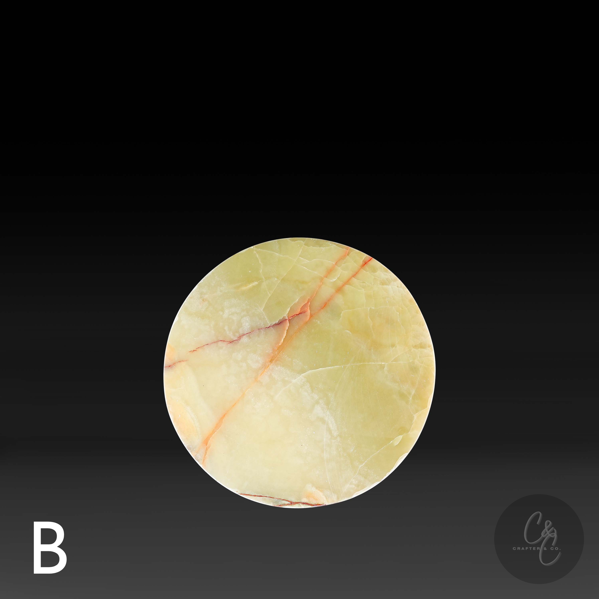 Round table top of green onyx cross side table with white and bronze veins pattern on a black background