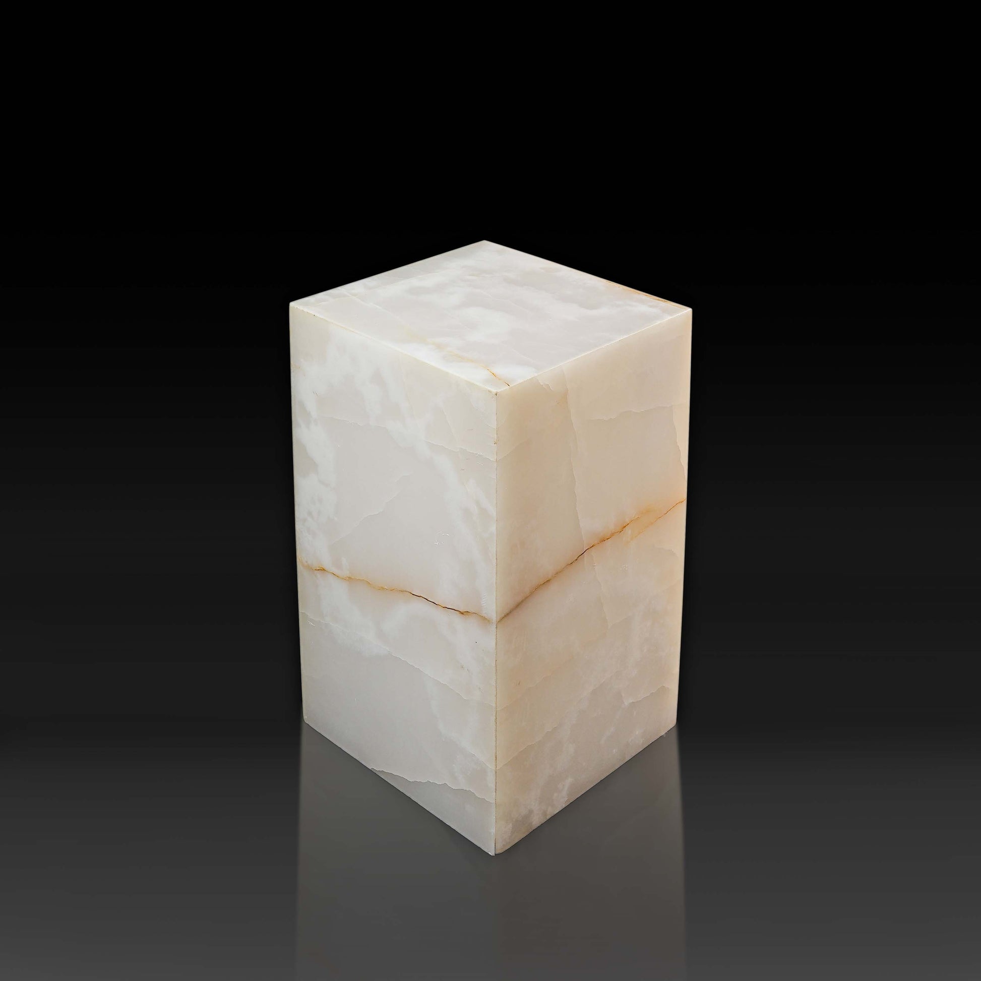 Top angle of the handcrafted White Onyx column side table showcasing the polished surface and natural translucent veining.