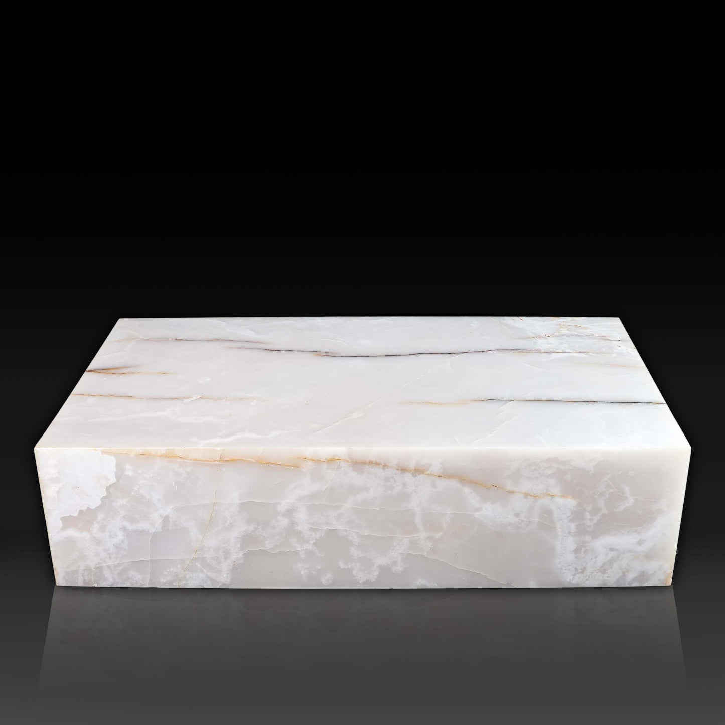 Front view of large White Onyx block coffee table with polished natural stone finish