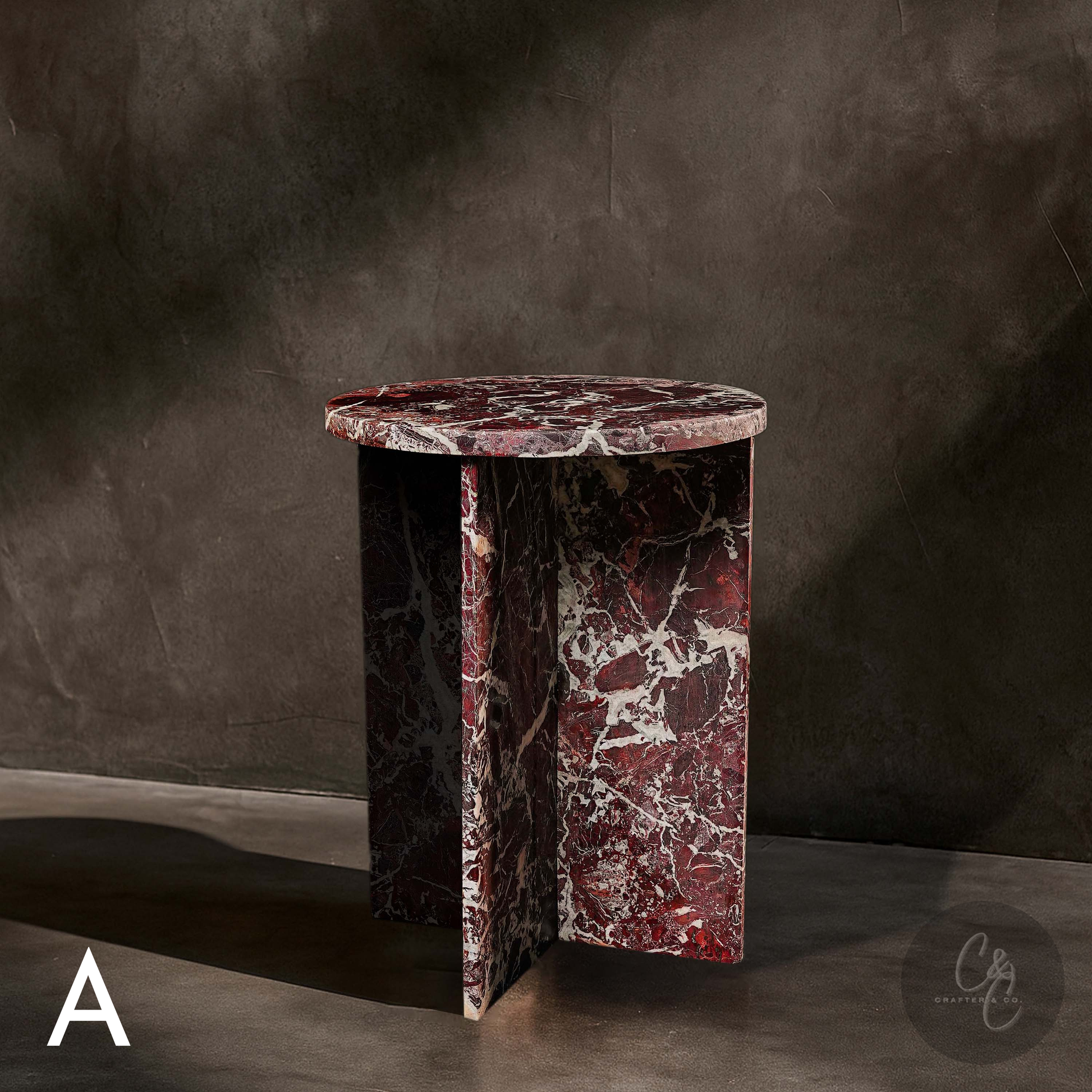 Round Cross Rosso Levanto marble side table angled view with honed finish