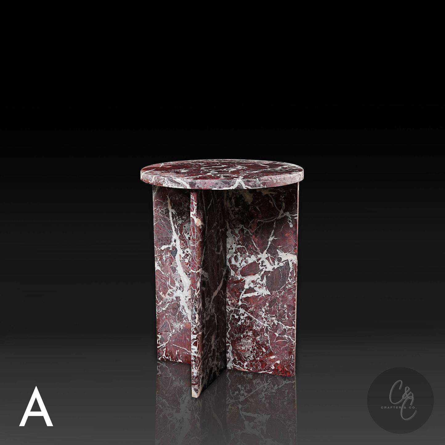 Round Cross Rosso Levanto marble side table with honed finish in studio setting
