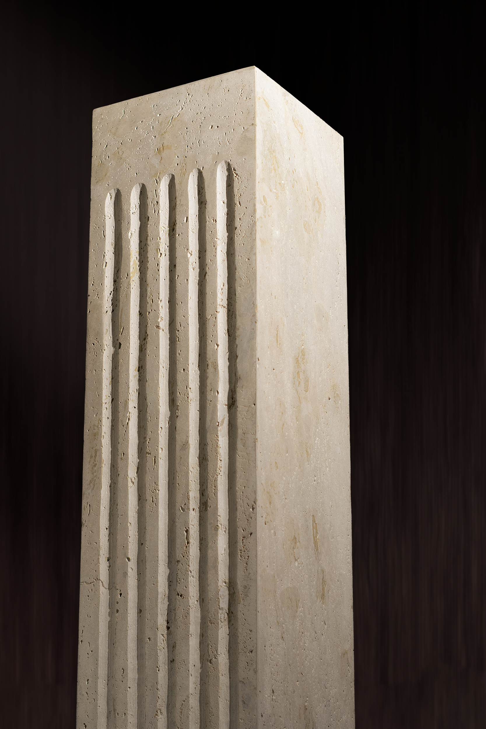Titanium Travertine Plinth with a wavy front design showcasing natural stone texture.