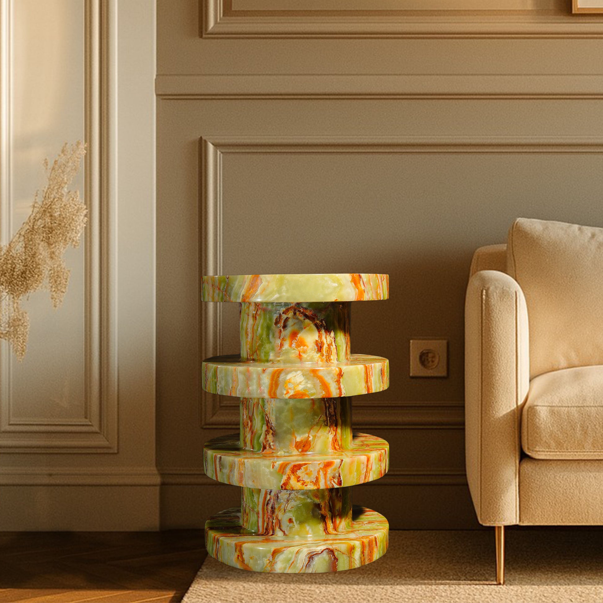 Vela Green Onyx Side Table styled beside a sofa, showcasing natural green onyx with rich green, gold and rust veining.