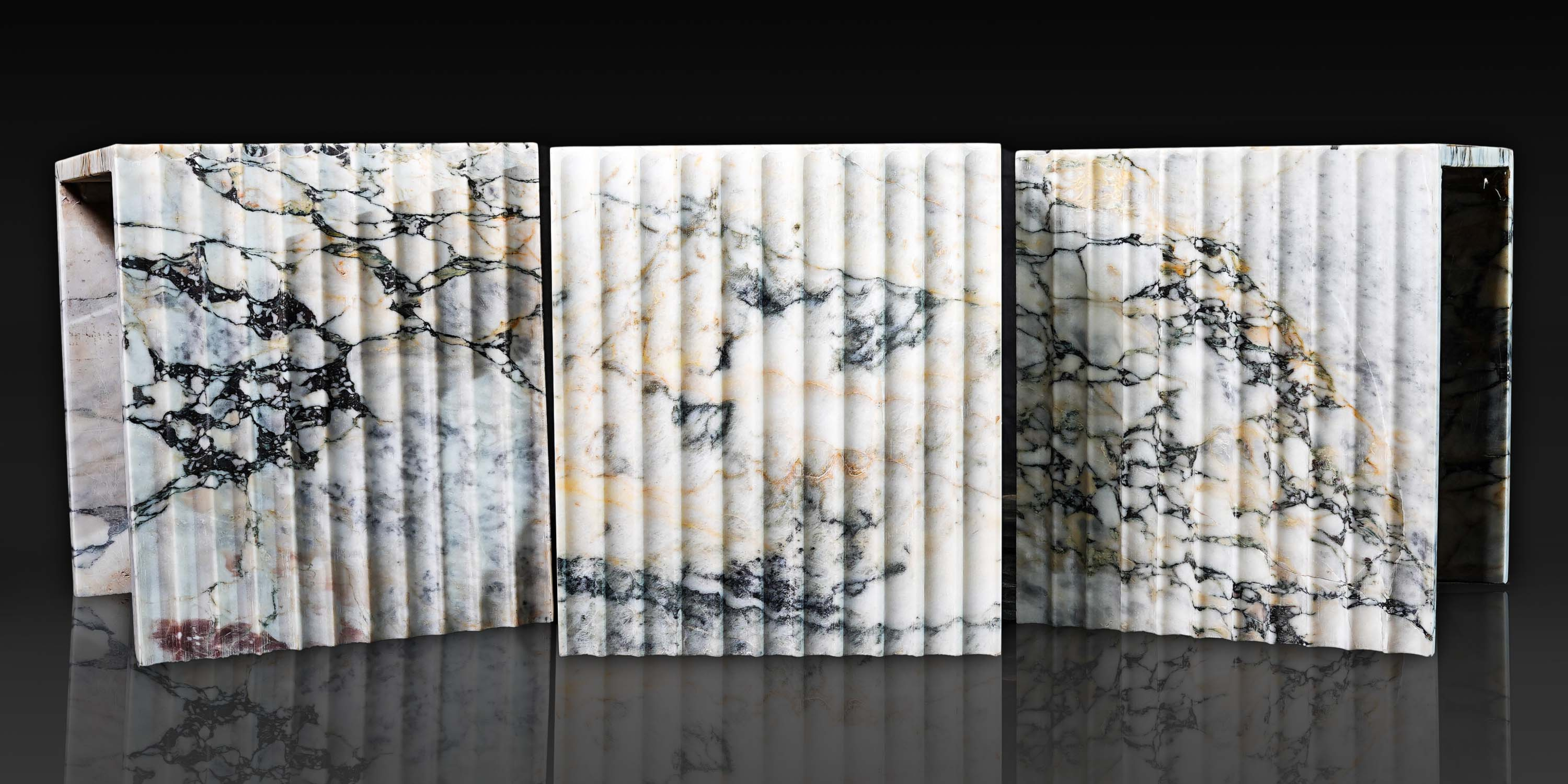 Three Arabescato Viola corrugated marble side tables handcrafted from natural stone.