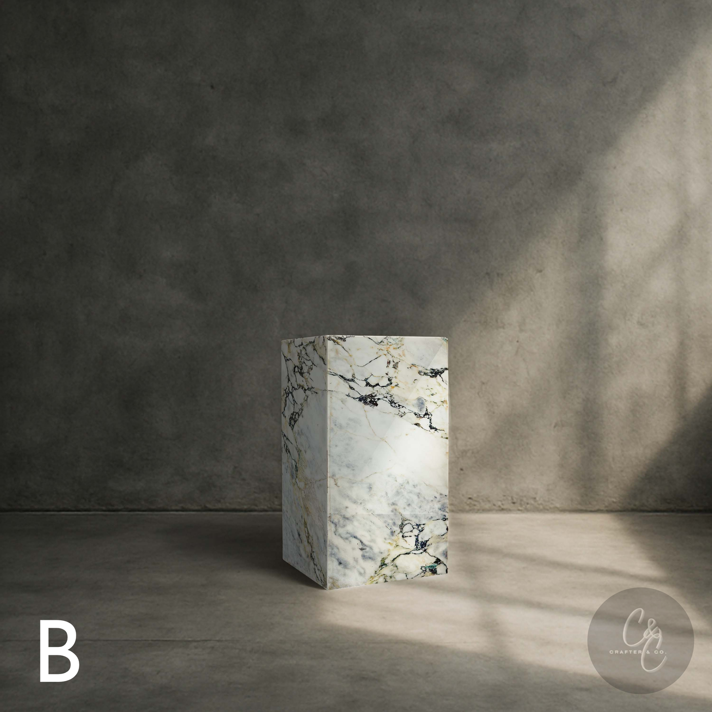 Arabescato Viola marble column side table styled in a contemporary interior showcasing natural Italian marble veining.