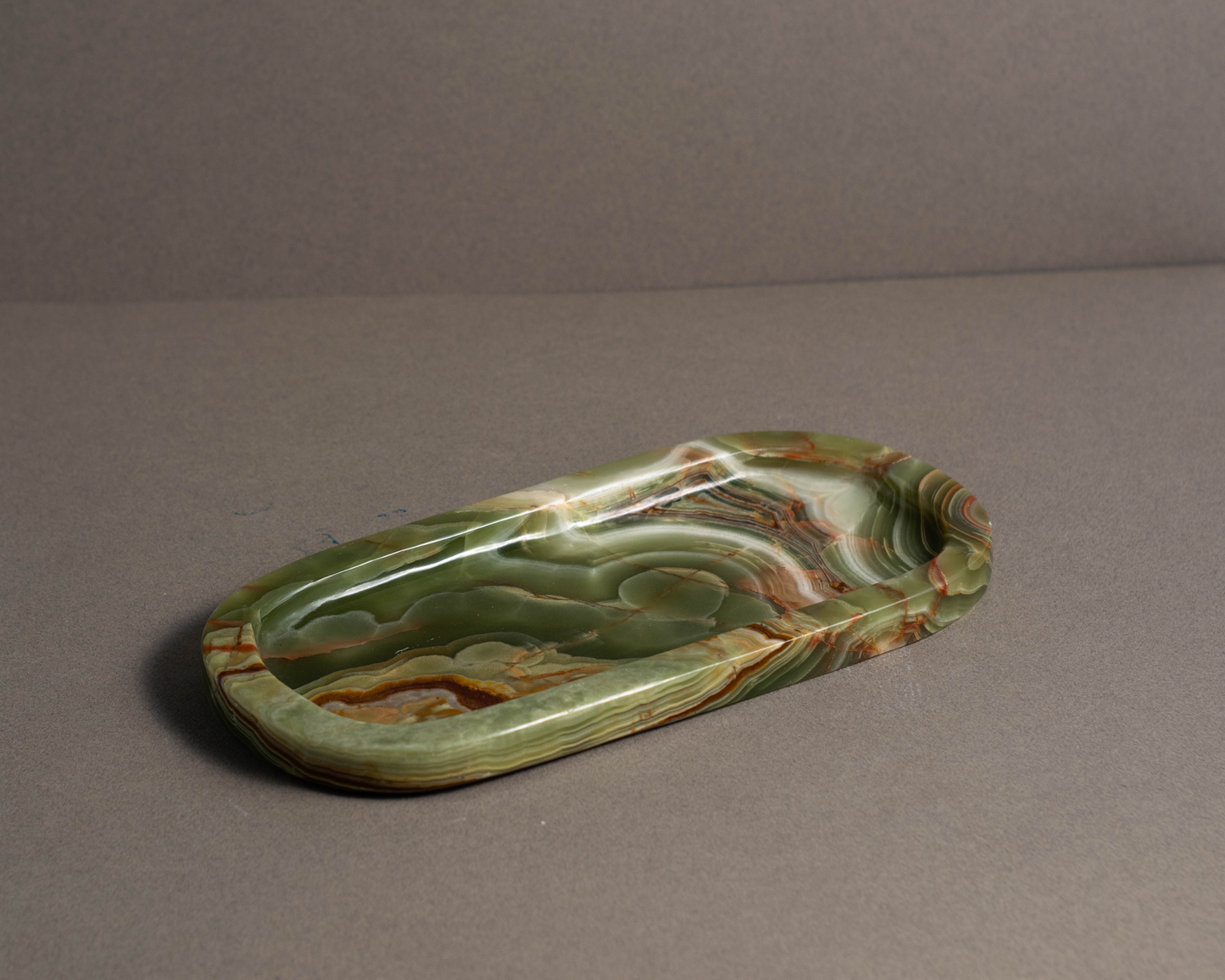 Aura Green Onyx Tray styled on a coffee table in a contemporary interior.