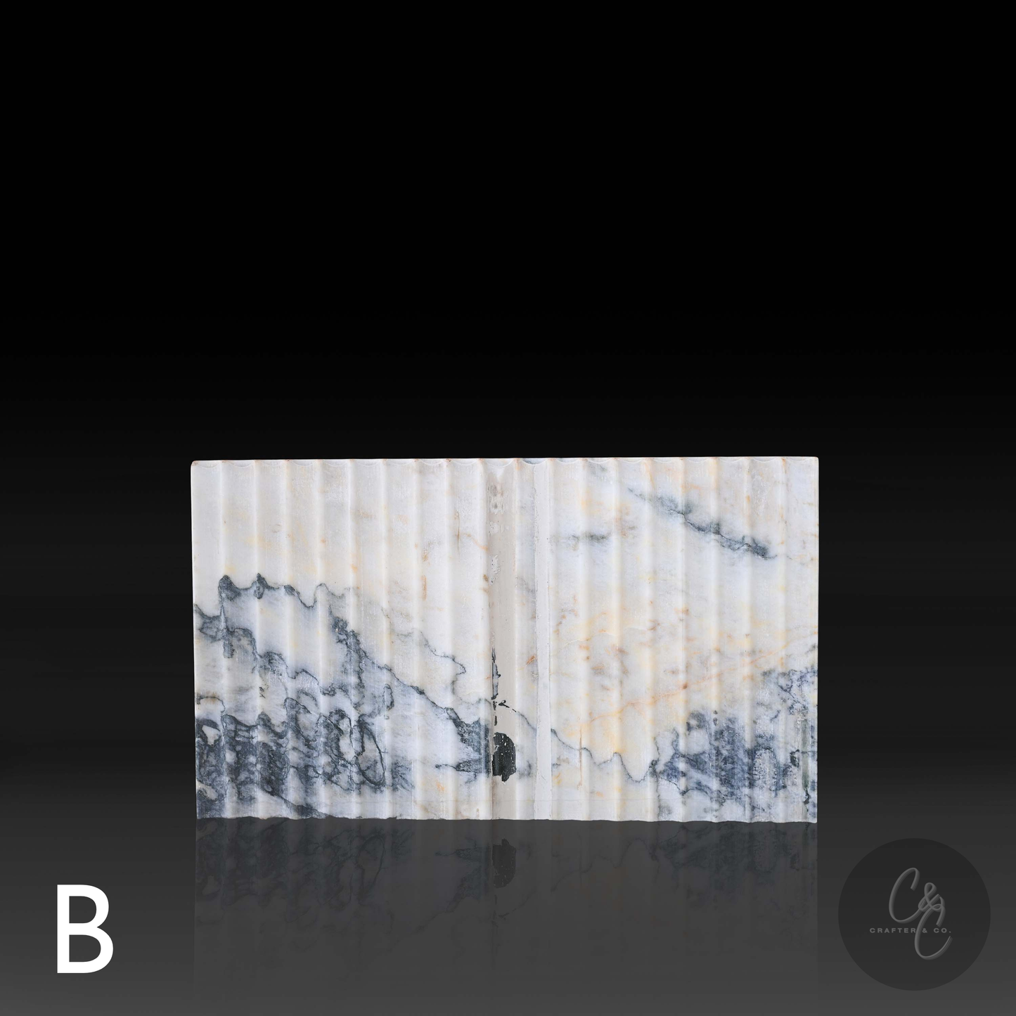 Close-up of the corrugated Calacatta Monet marble variant B highlighting the fluted texture and natural veining.