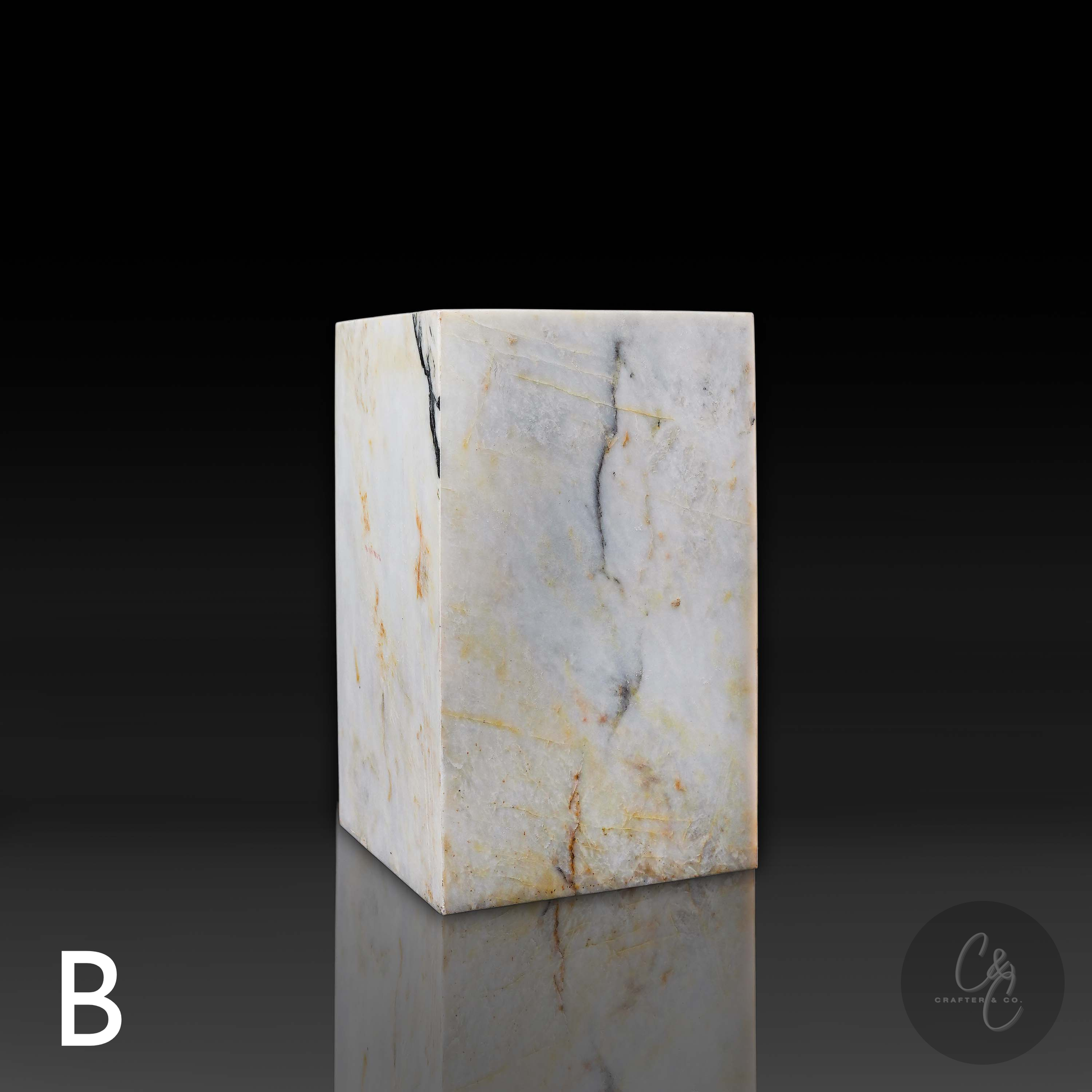 Side profile of handcrafted Calacatta Monet marble side table highlighting unique white marble veining and natural stone beauty.