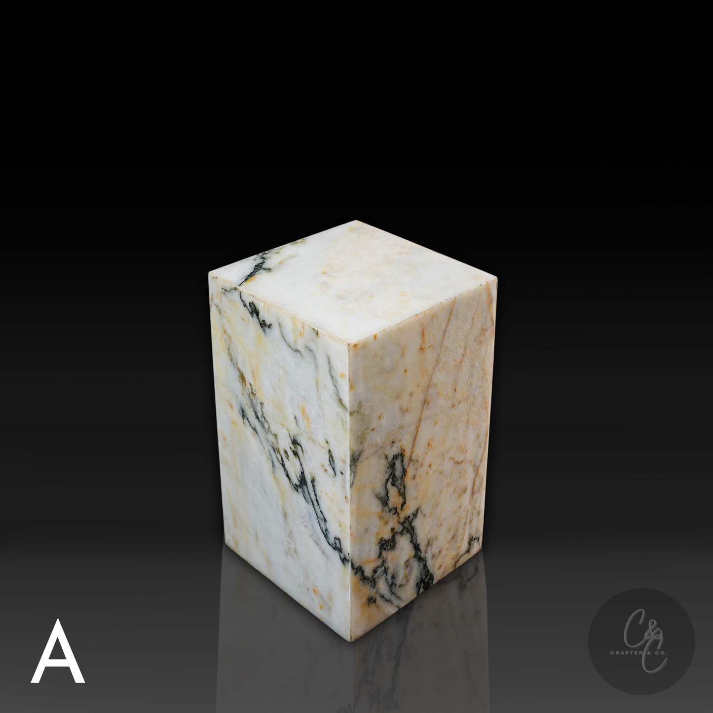 Top angled view of Calacatta Monet marble column side table displaying luxurious natural stone character.