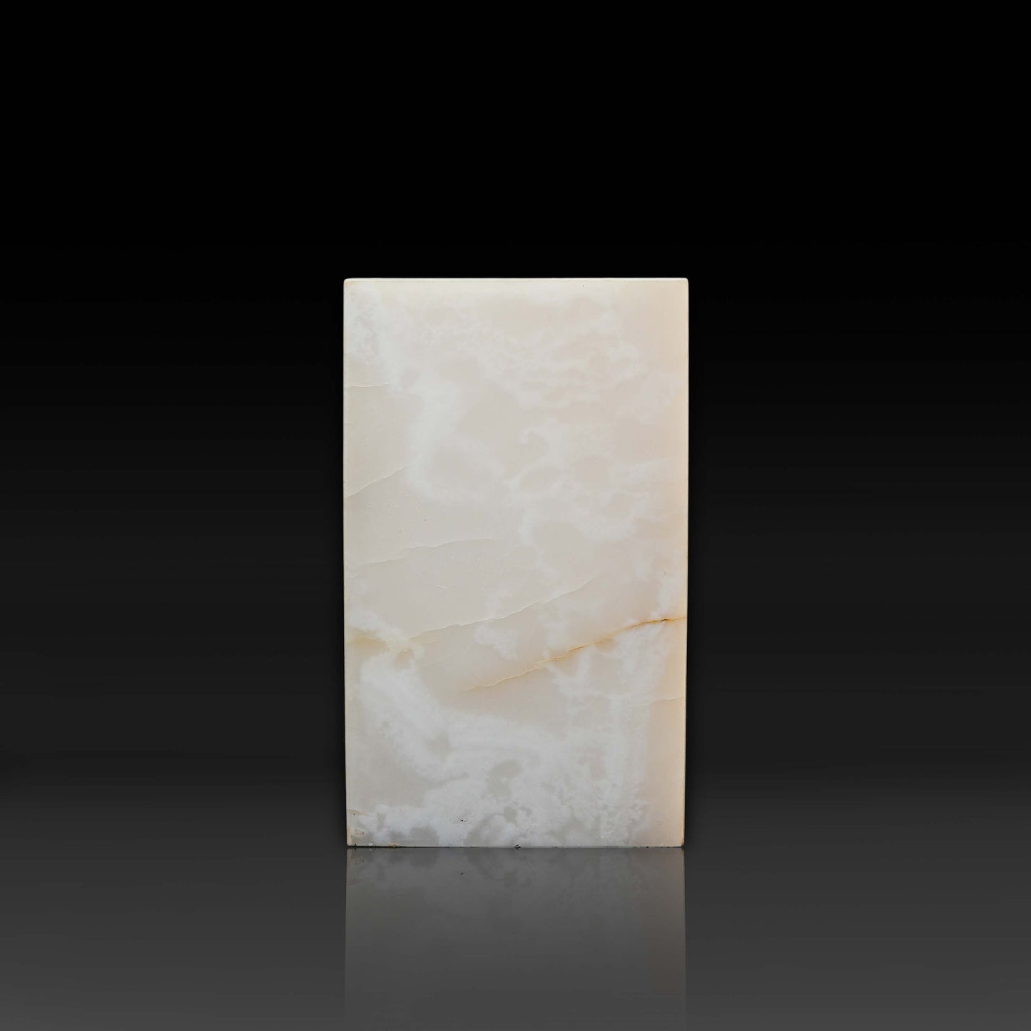 Front view of the handcrafted White Onyx column side table with polished finish and natural golden veining.