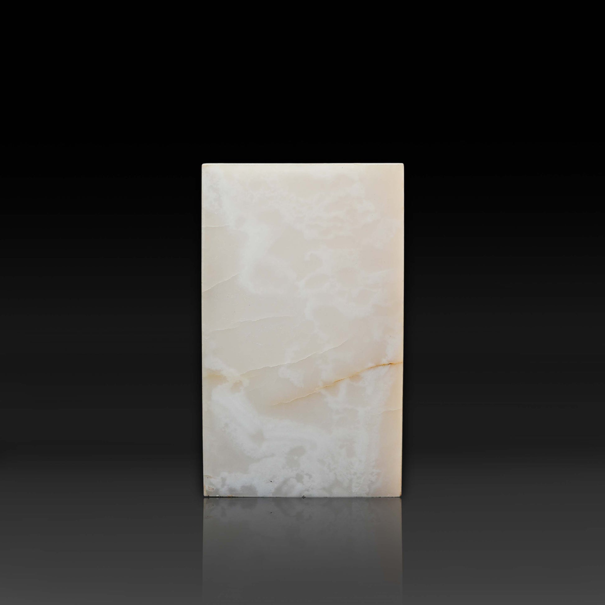 Front view of the handcrafted White Onyx column side table with polished finish and natural golden veining.