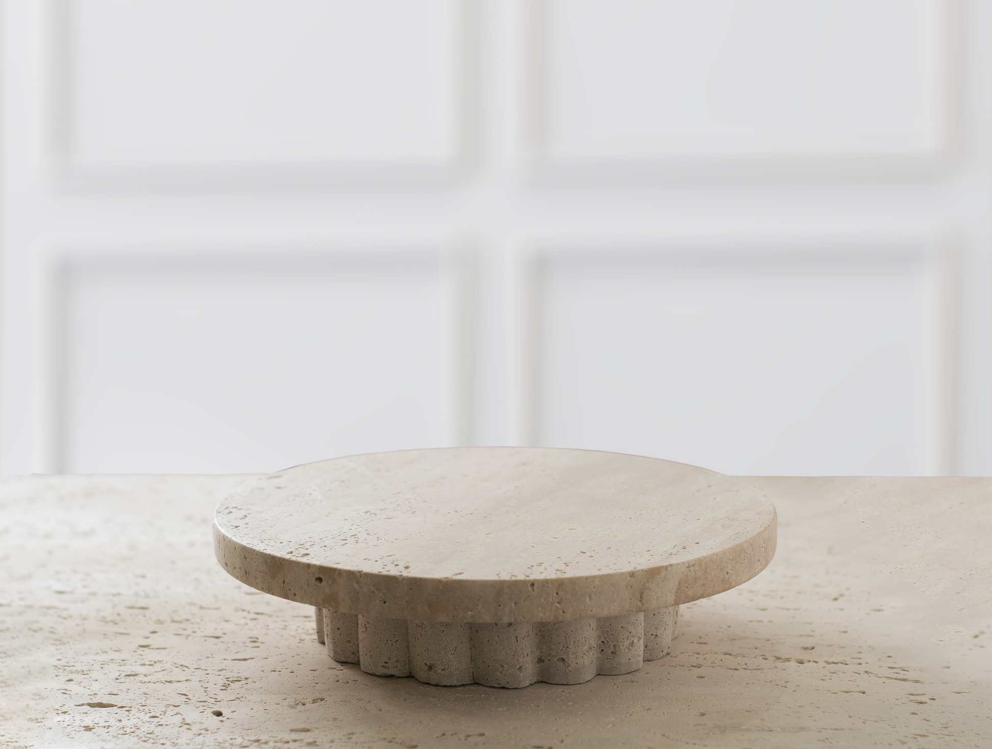 Column Travertine Round Tray handcrafted from natural travertine with a sculptural column base