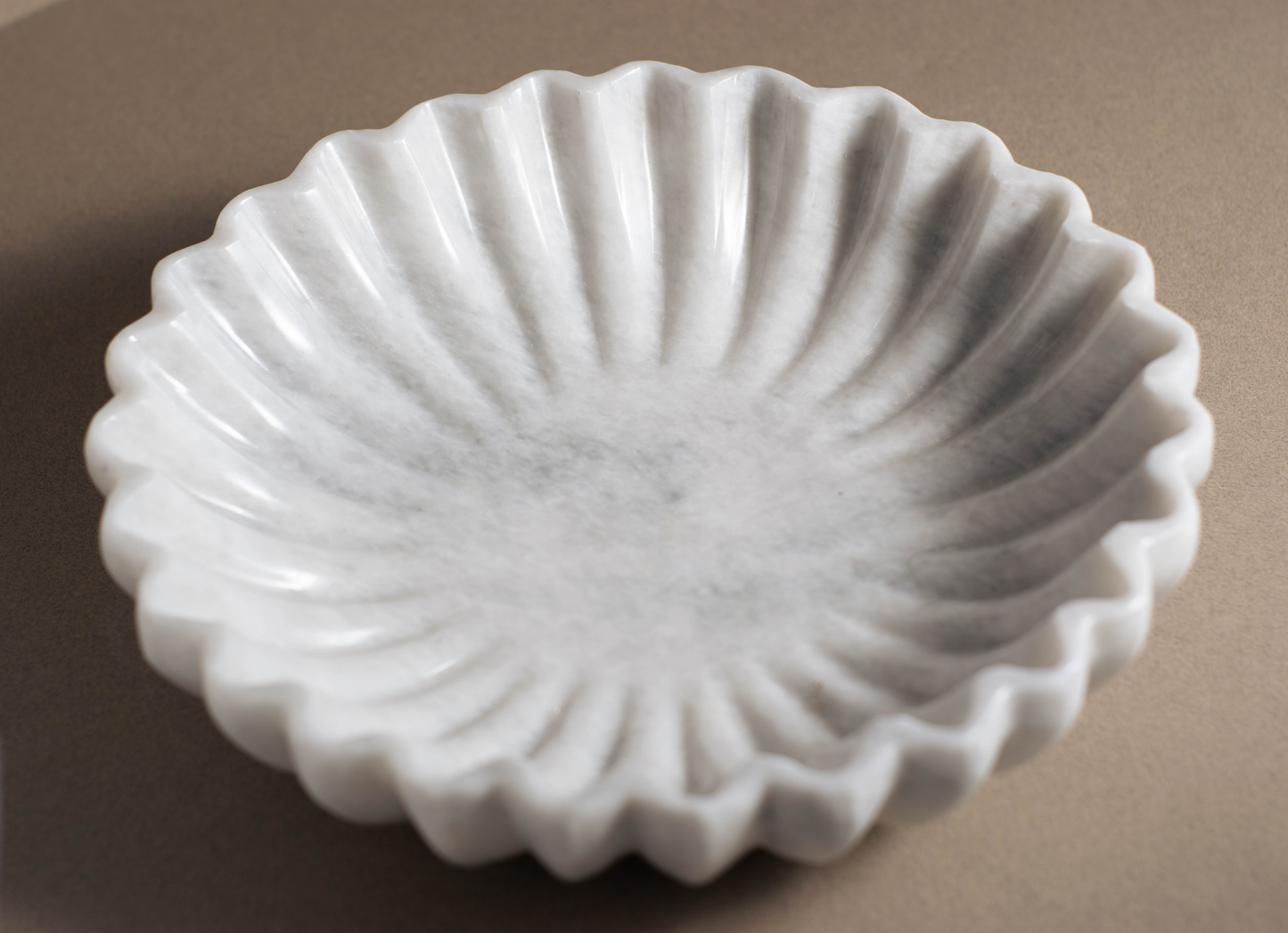 Top view of the Coral White Marble Bowl displaying its organic fluted design in natural white marble.