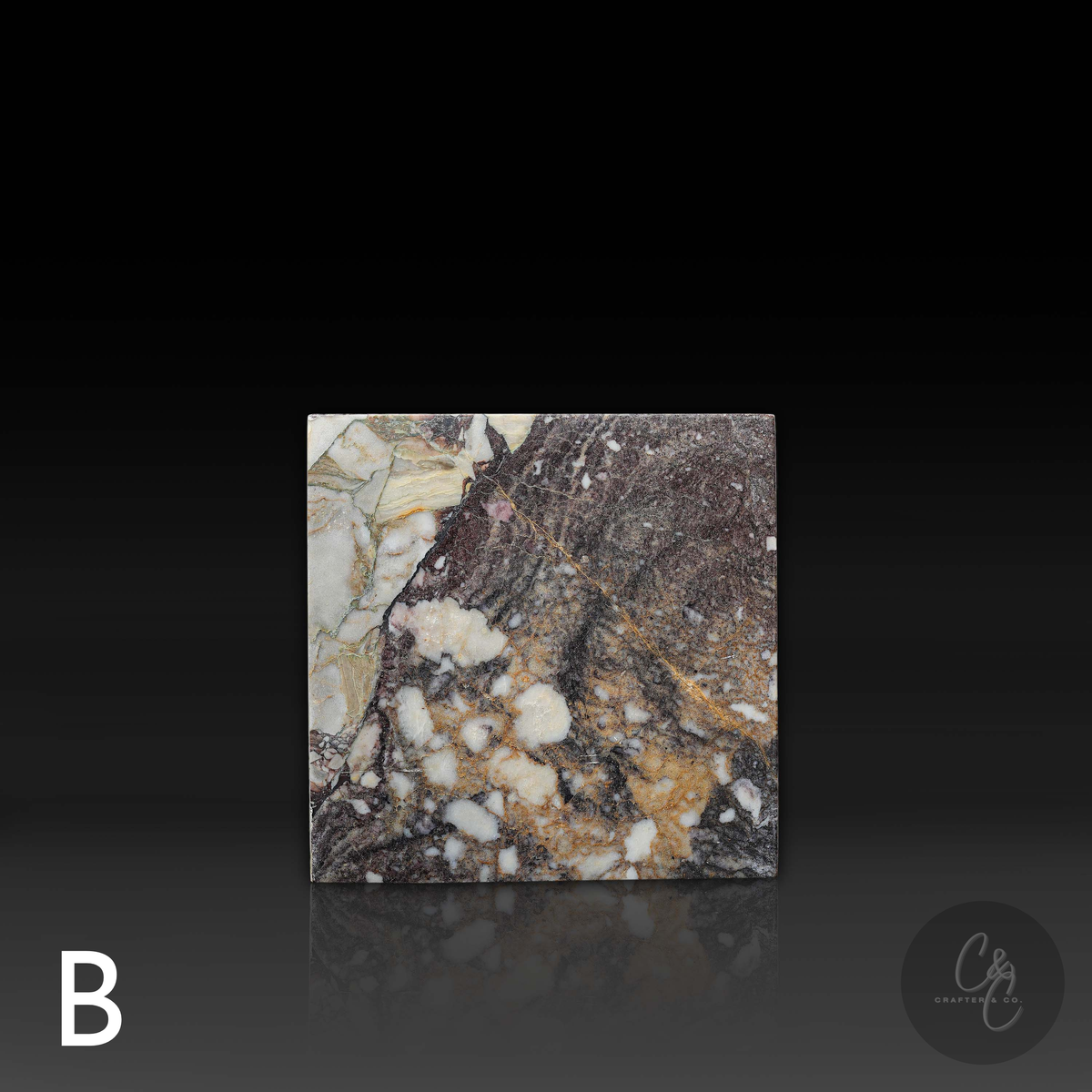 Cube Side Table in Breccia Capraia marble front view highlighting bold natural stone patterns.