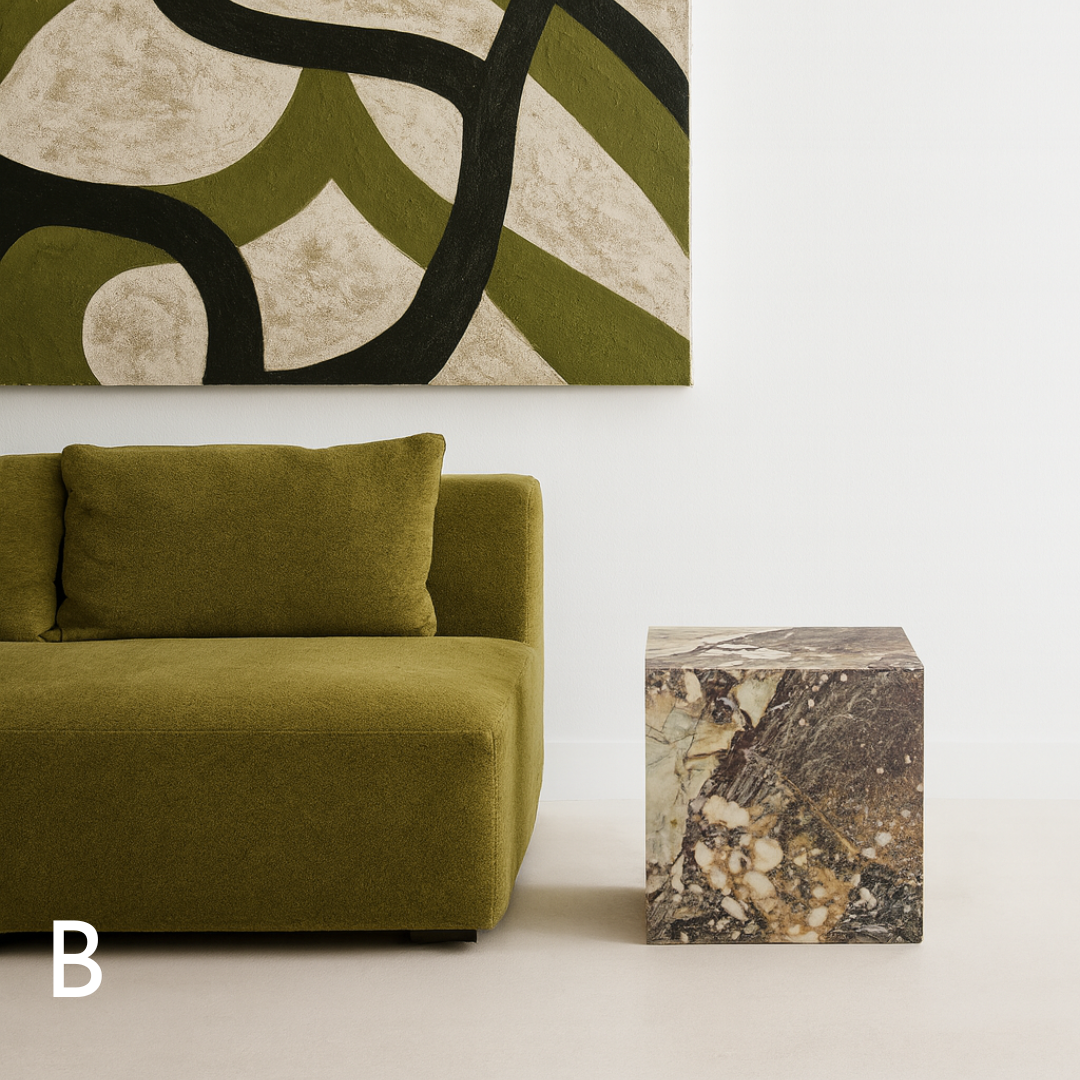Cube Side Table in Breccia Capraia marble styled beside a green sofa in a contemporary living room.