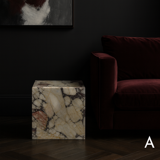 Cube Side Table in Breccia Capraia marble styled beside a burgundy sofa in a contemporary living room