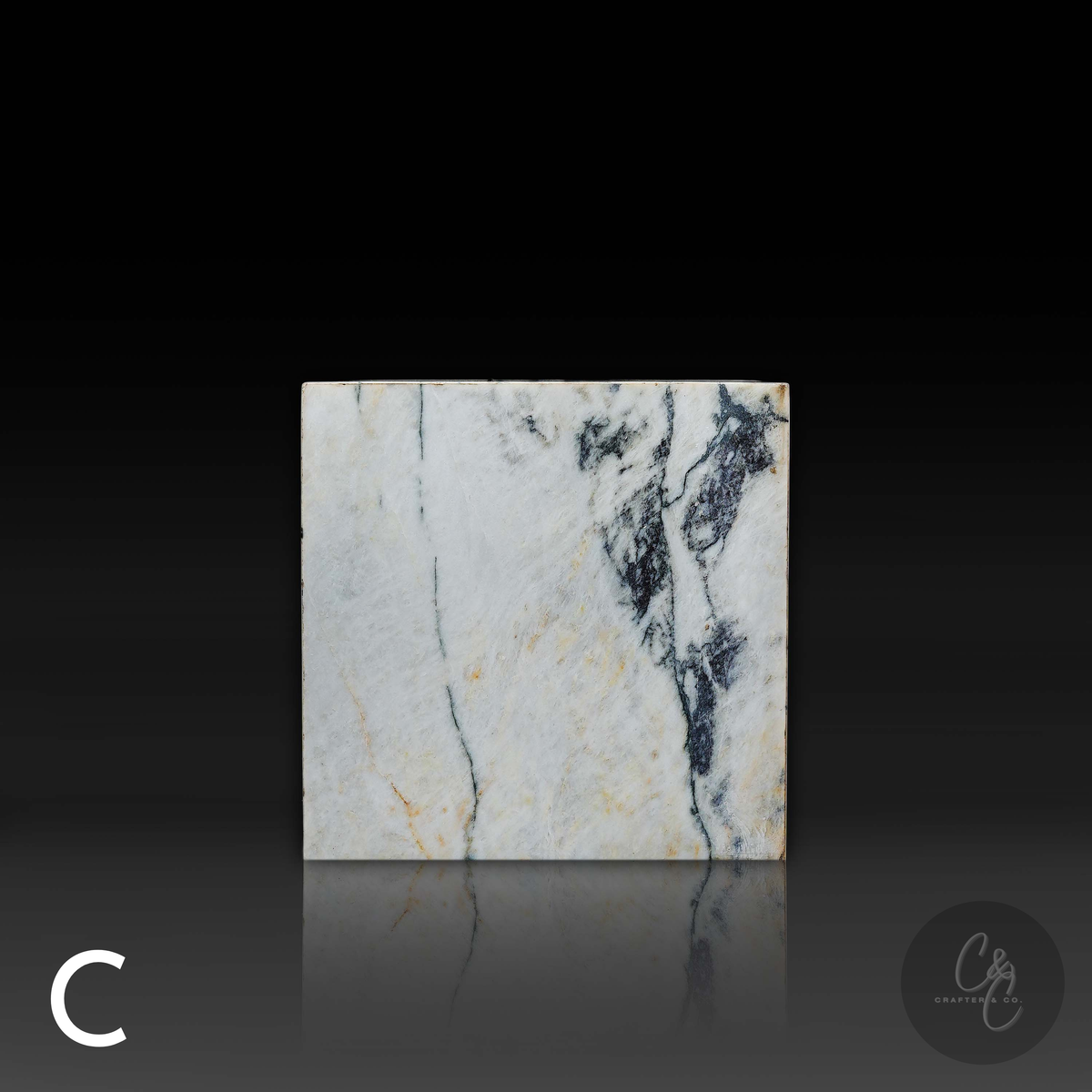 Cube Side Table in Calacatta Monet marble front view with bold natural stone veining.