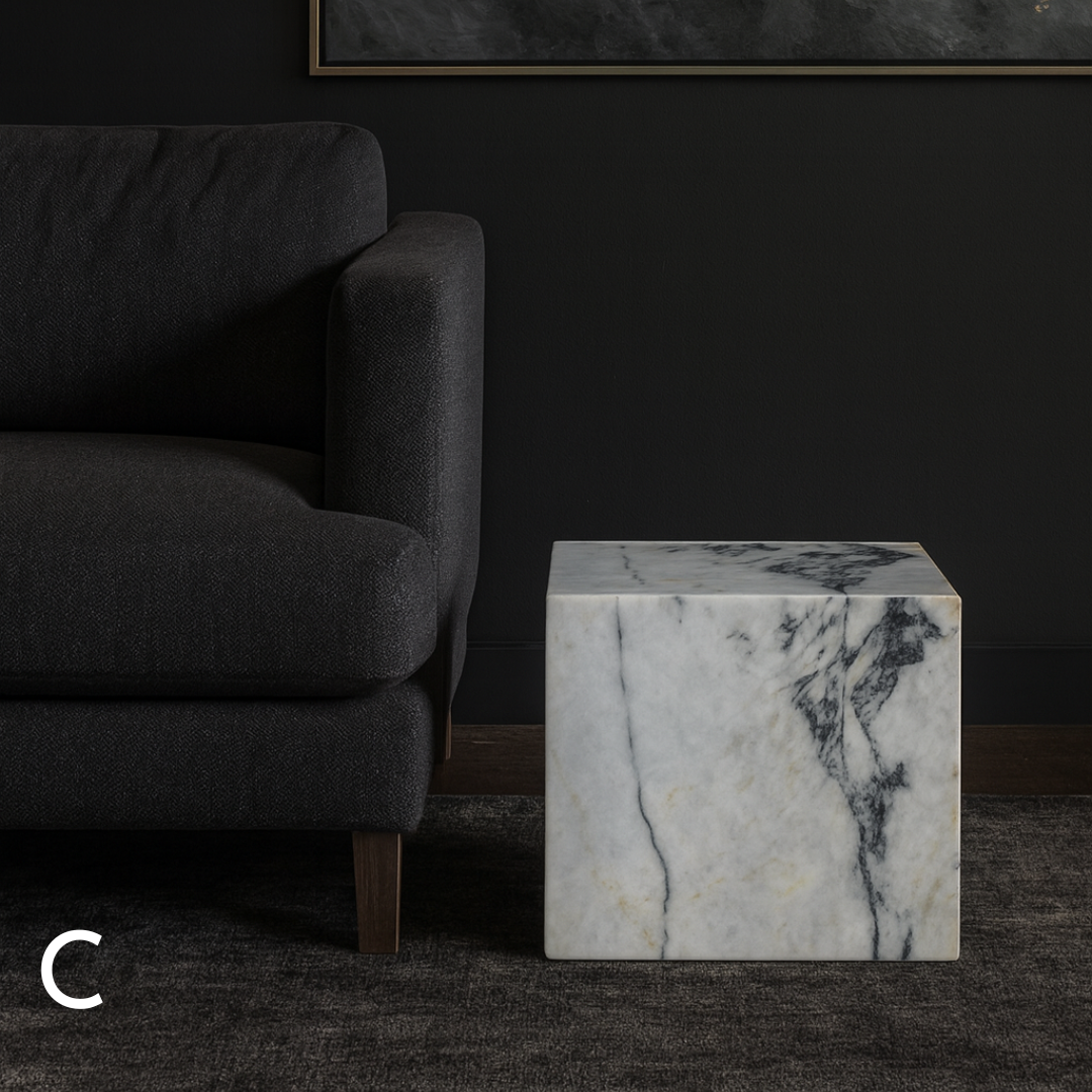 Cube Side Table in Calacatta Monet marble styled beside a charcoal sofa in a contemporary living room.