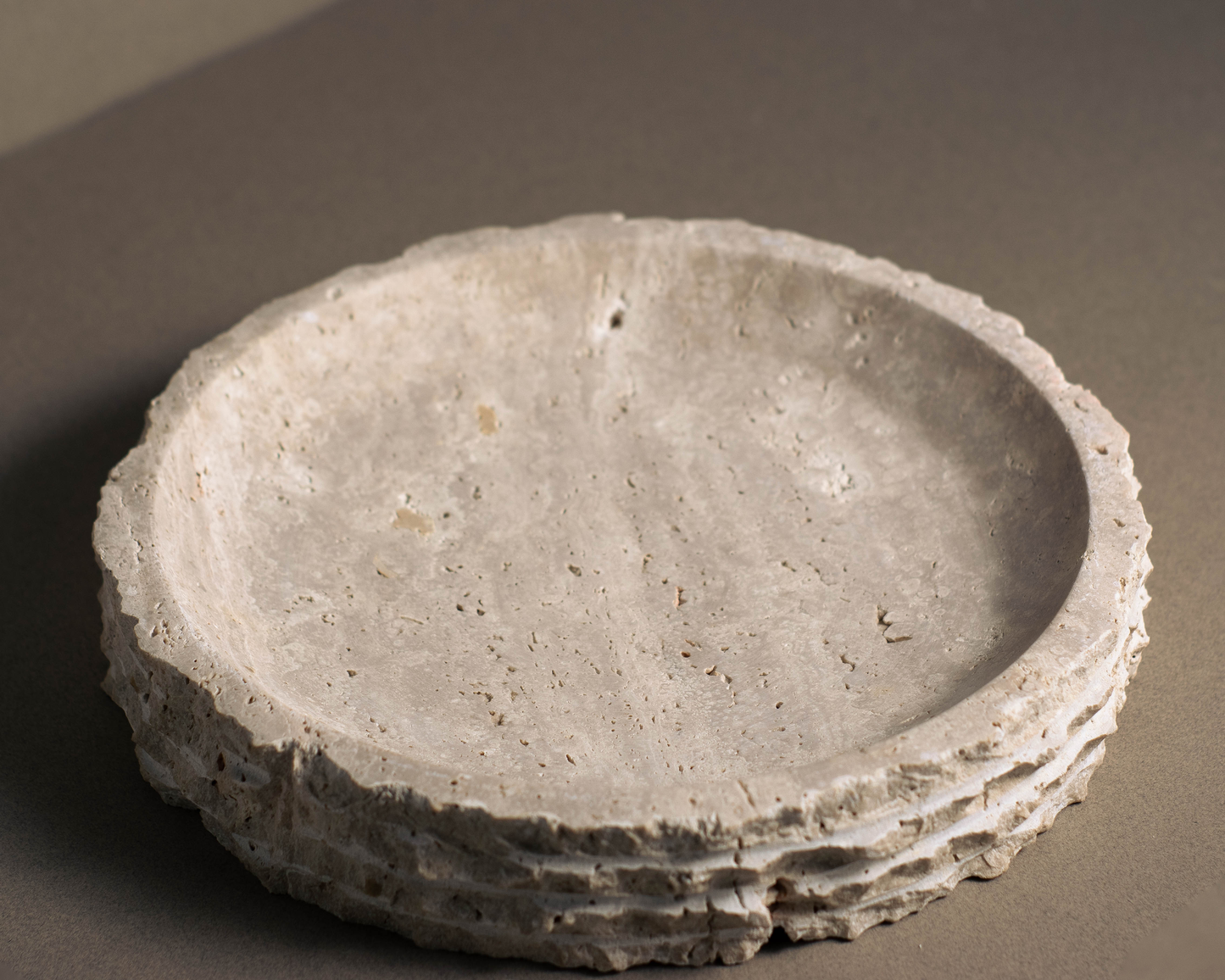 Top view of the Eclipse Travertine Bowl showcasing natural travertine texture and handcrafted layered detailing.