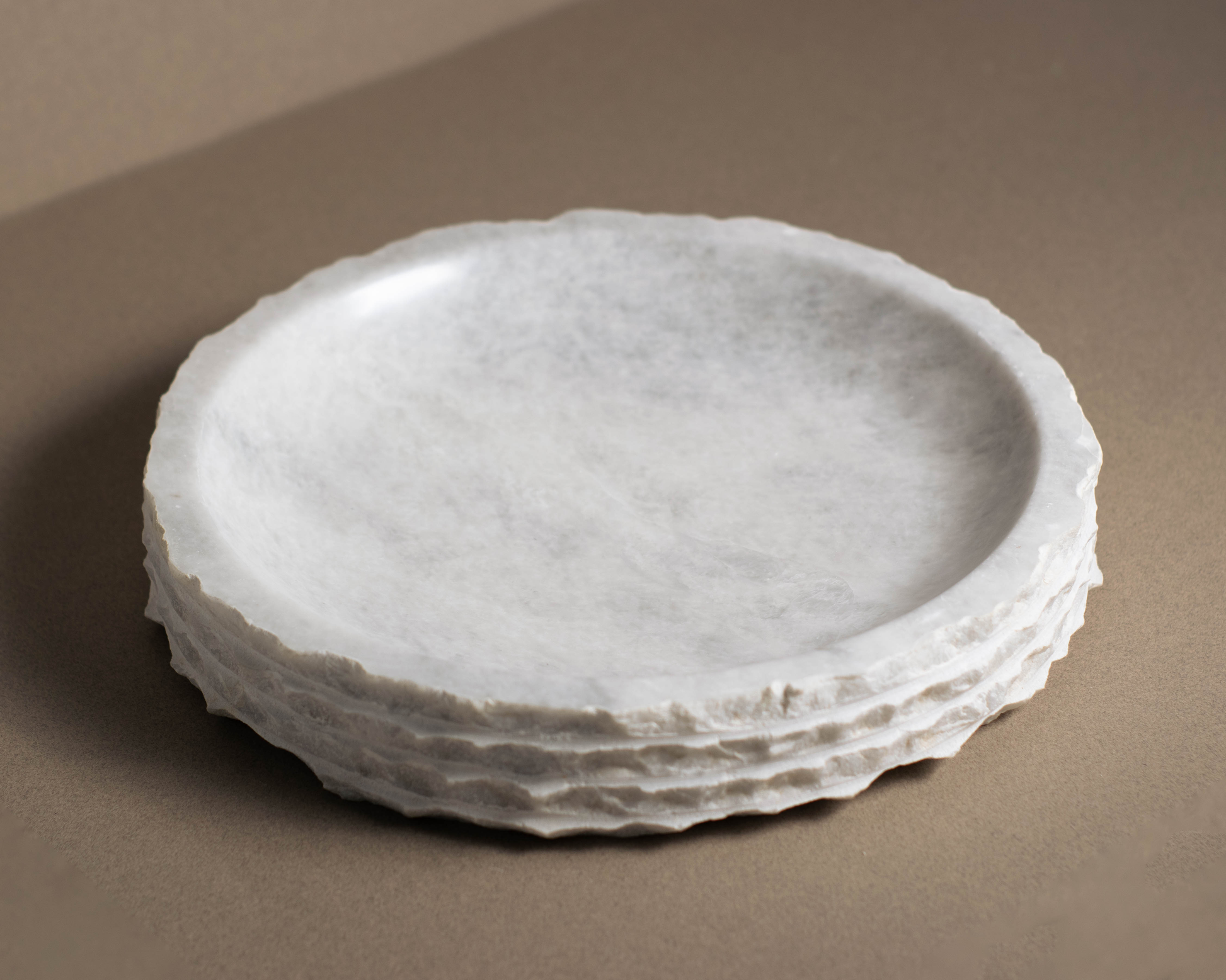 Top view of the Eclipse White Marble Bowl showcasing natural white marble veining and an organic sculptural form.