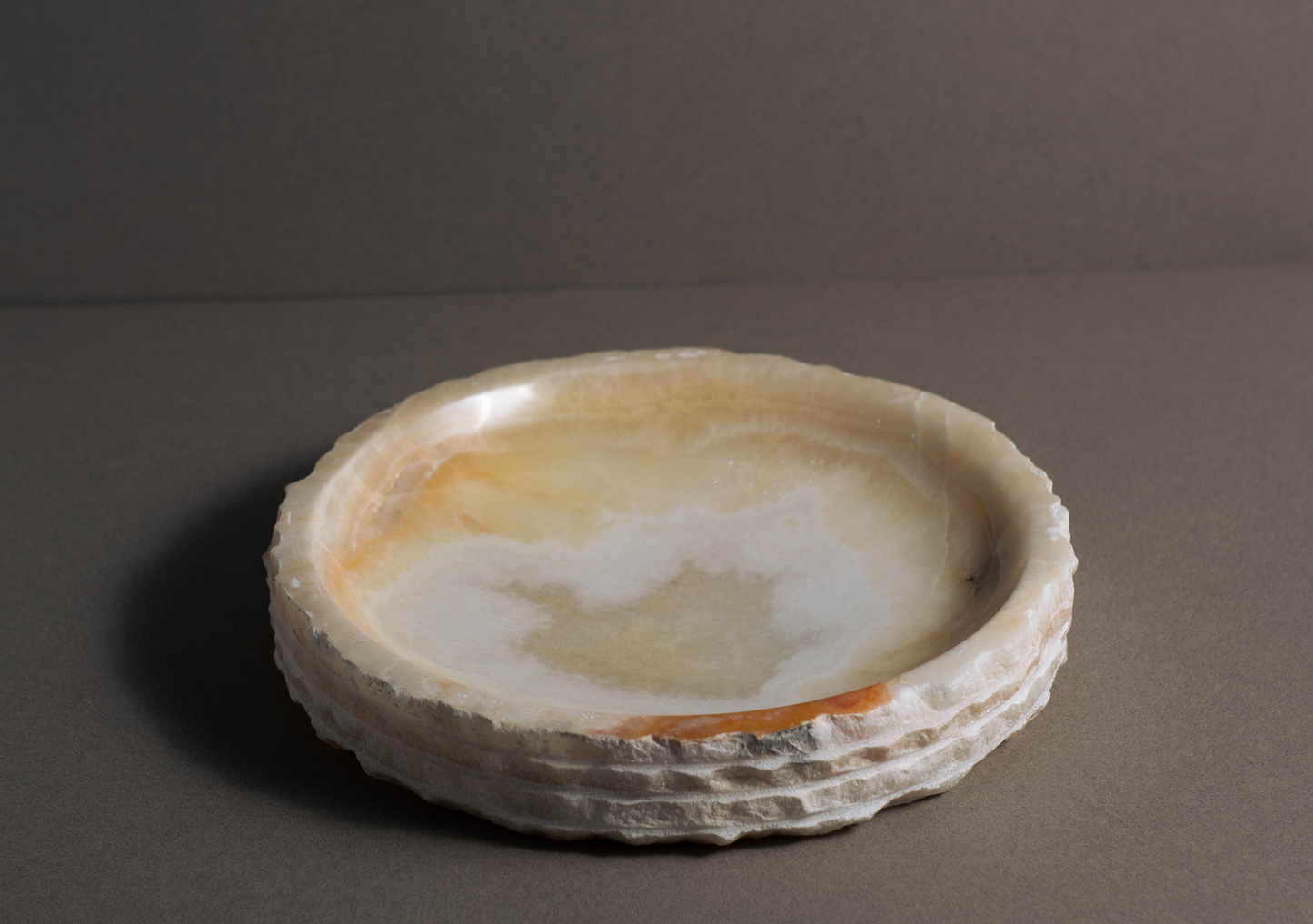 Eclipse White Onyx Bowl displayed from a front angle showcasing its handcrafted layered profile and natural stone beauty.