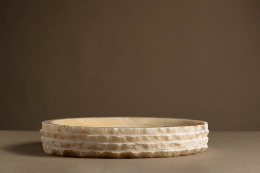 Eclipse White Onyx Bowl handcrafted from natural white onyx with layered sculptural edges and translucent veining.