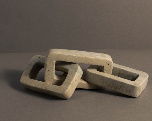 Natural travertine chain link for coffee table and shelf styling.