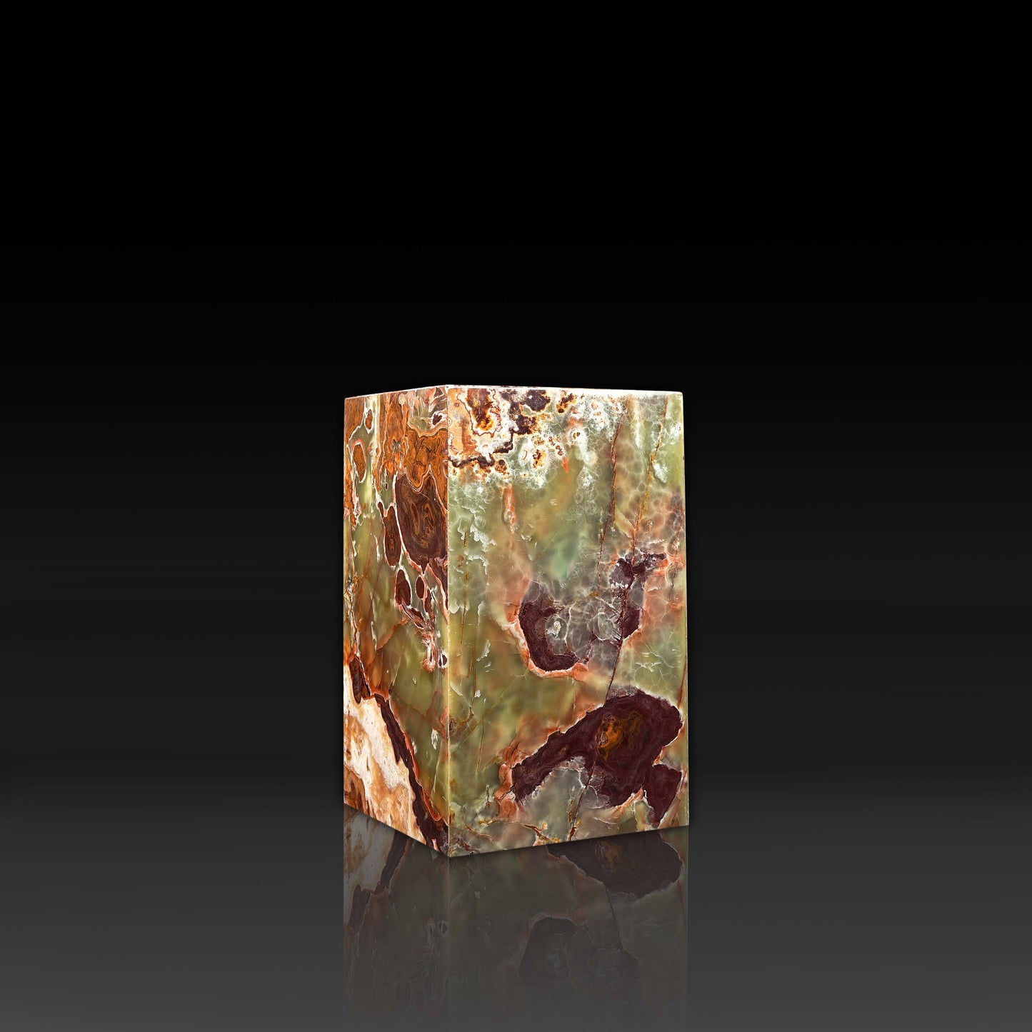 Front angle view of handcrafted Green Onyx column side table showcasing rich green, amber and rust veining.