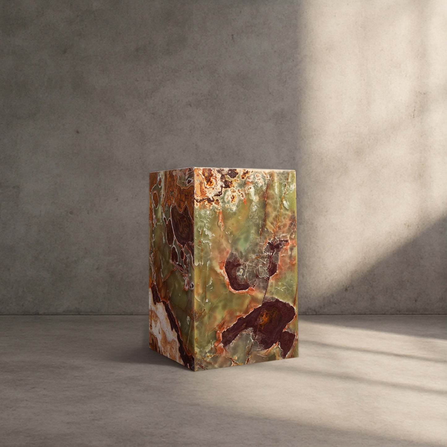 Handcrafted Green Onyx column side table styled in a modern interior with warm natural light.
