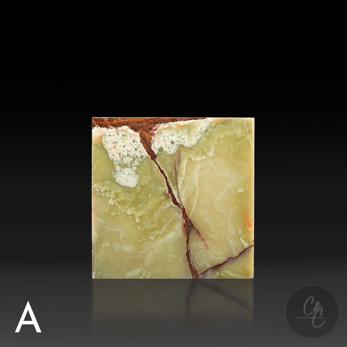 Green onyx cube side table variation A shown from the front, featuring distinctive rust and ivory veining.