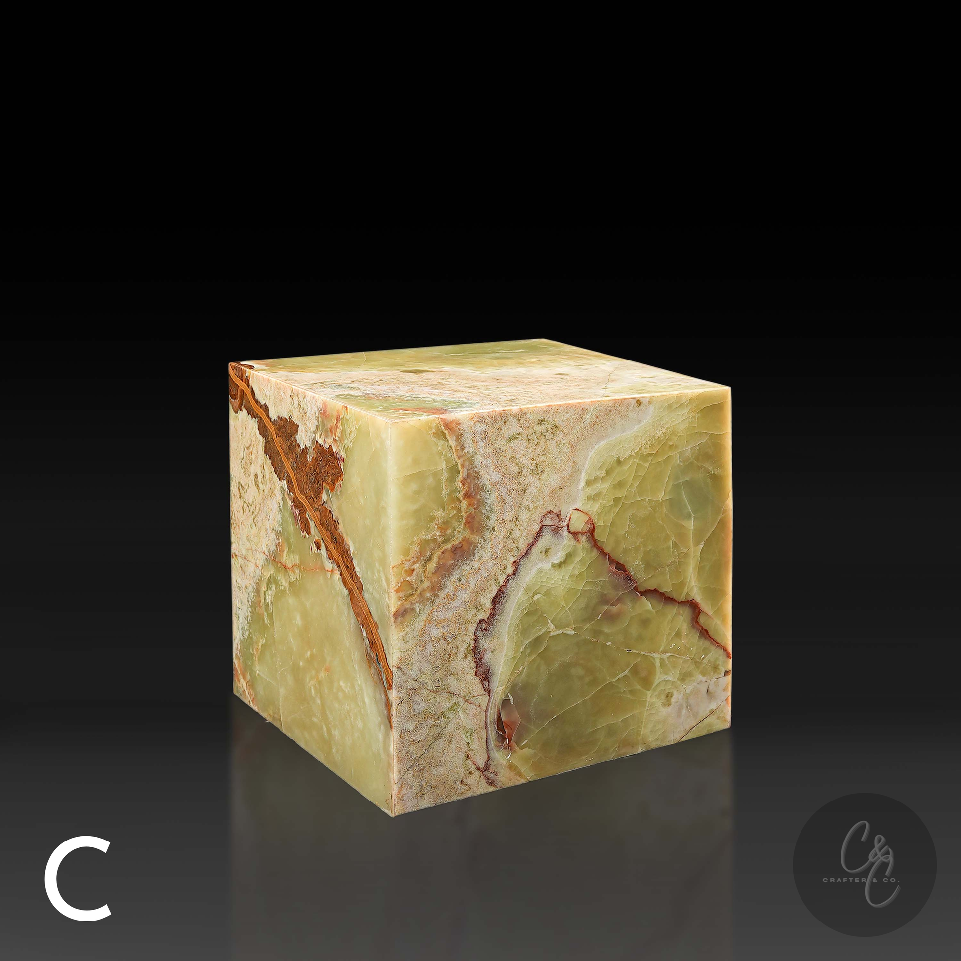 Green onyx cube side table variation C shown from the front profile, highlighting its rust and ivory veining.