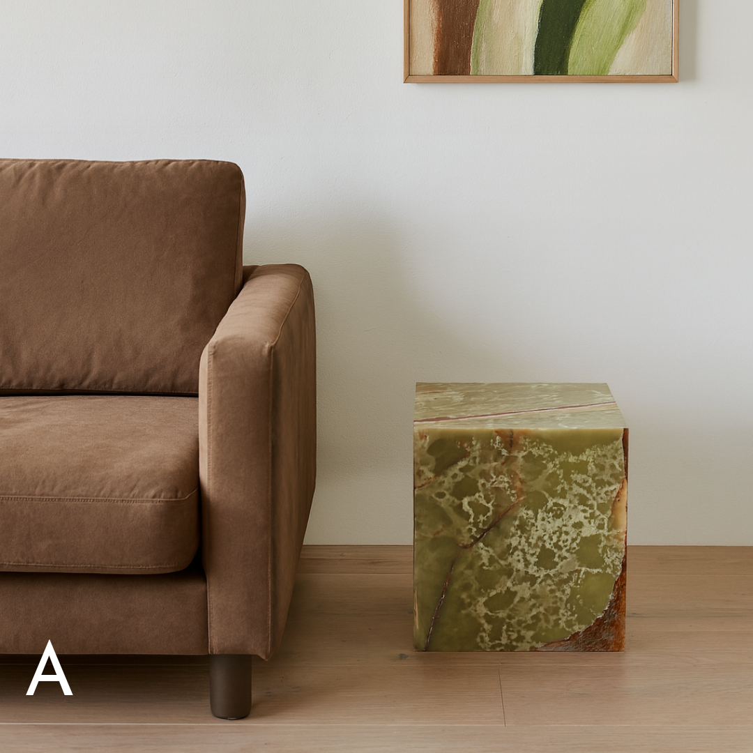 Green onyx cube side table variation A styled beside a brown sofa in a refined living room.