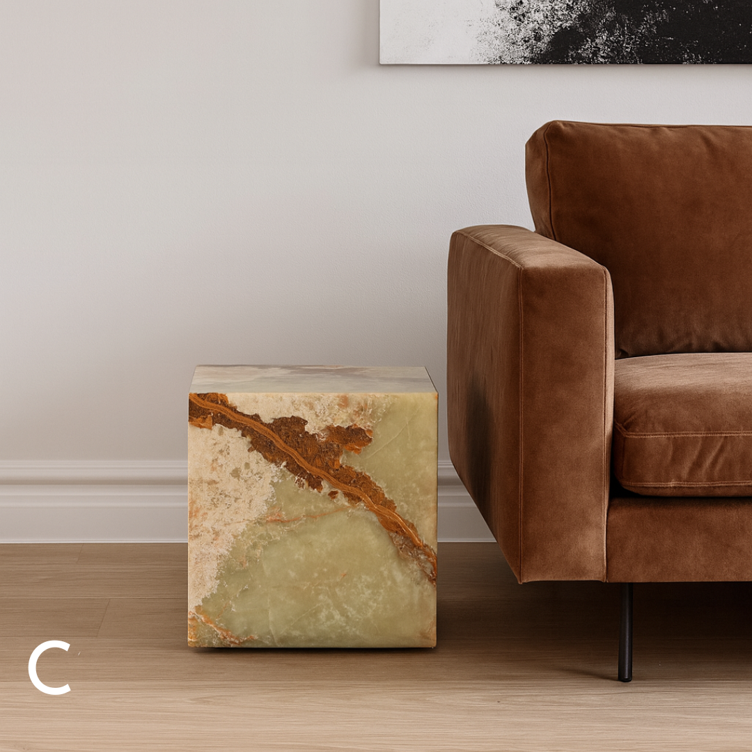 Green onyx cube side table variation C styled beside a brown sofa in a refined living room.