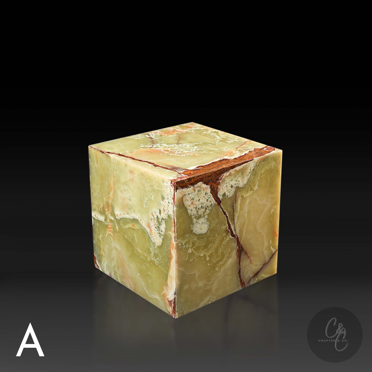 Green onyx cube side table variation A shown from a top angle, highlighting its polished surface and natural veining.