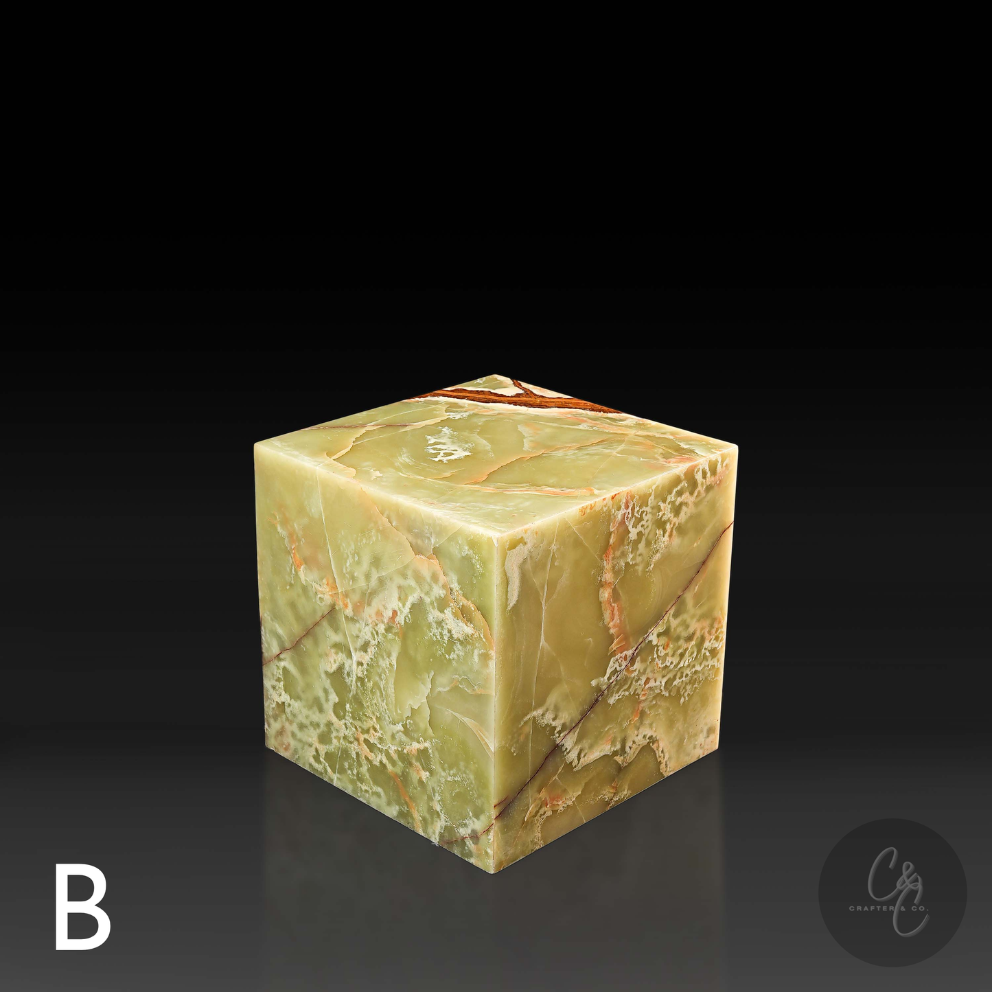 Green onyx cube side table variation B shown from a top angle, highlighting its polished surface and natural veining.